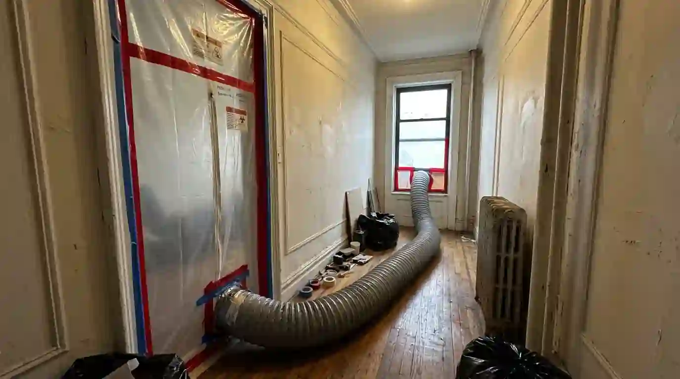 Containment set up in a prewar apartment hallway for mold work